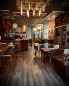 Cosy interior of Sheldon's wine bar, with leather sofa and wooden floor.