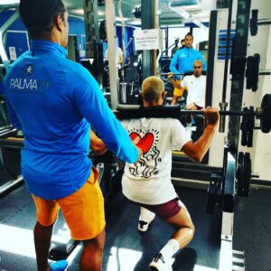 Gilberto enccouraging a client in the gym